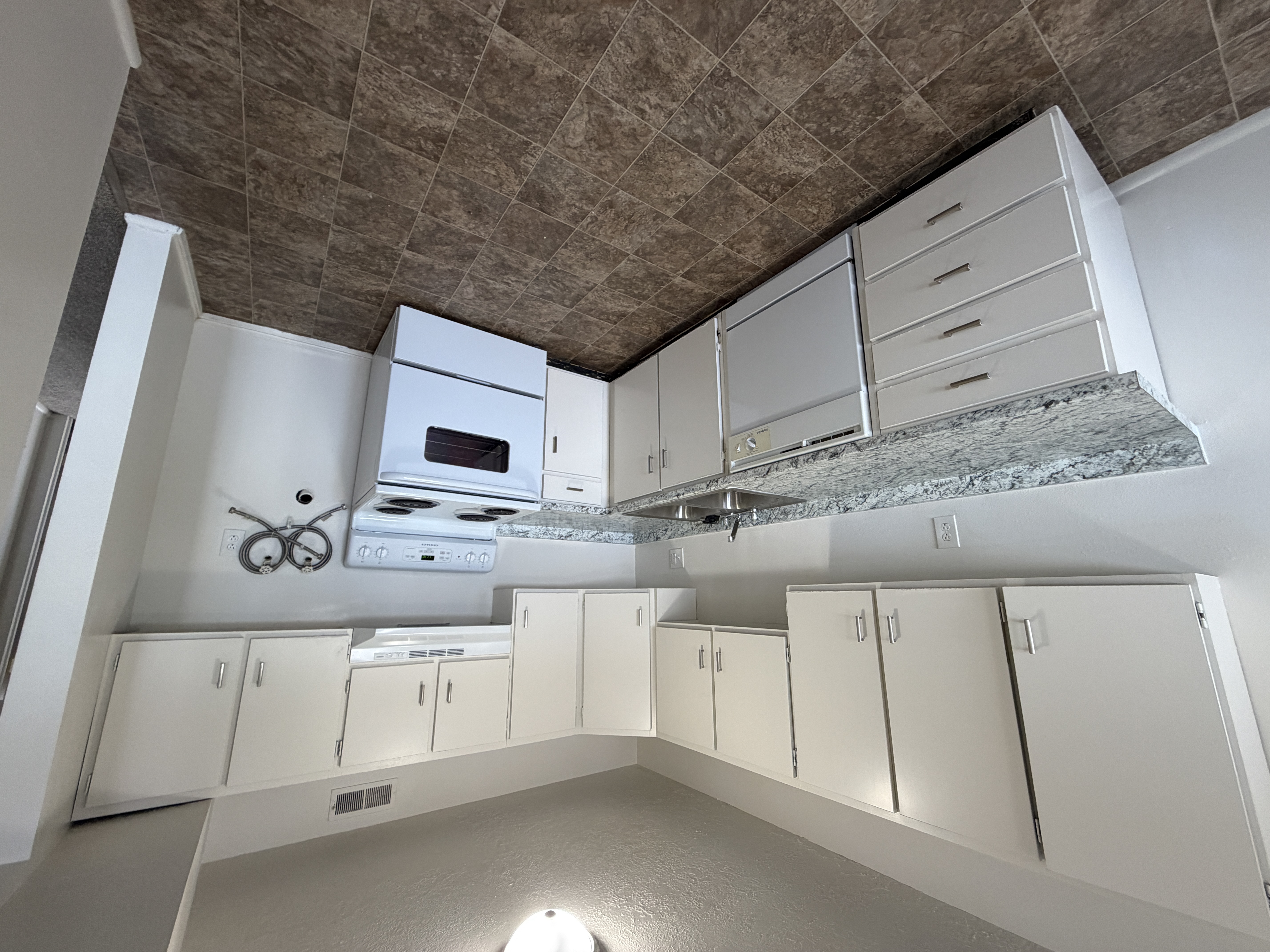 Kitchen with white cabinets and granite countertops